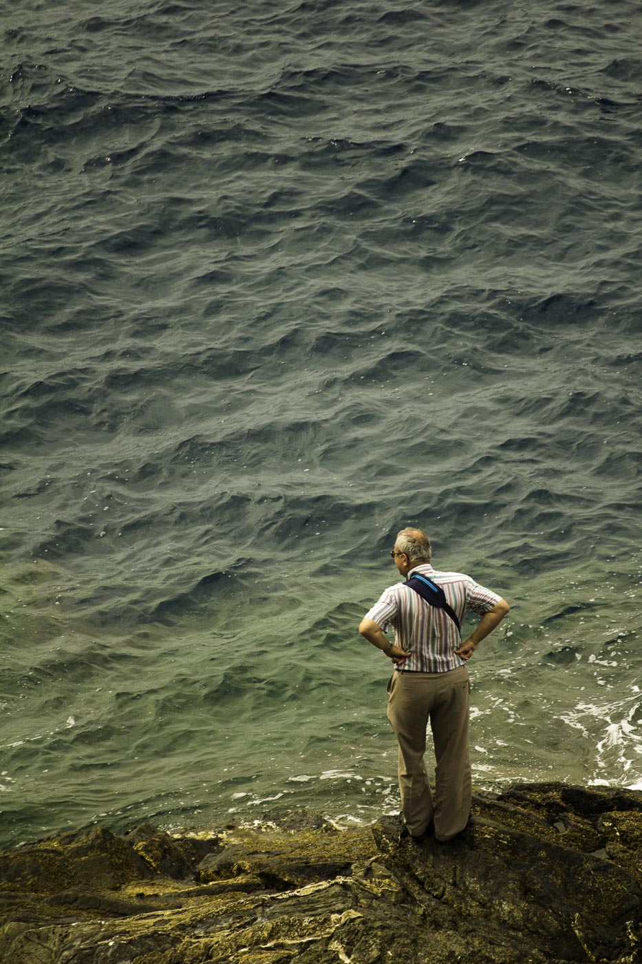 Old man looking at the sea